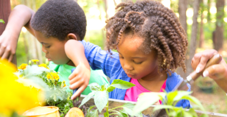 Two young African children gardening