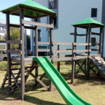 Jungle gym with a slide in a community scheme garden
